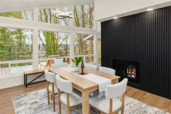Two-sided fireplace separates the living area and kitchen/dining areas.