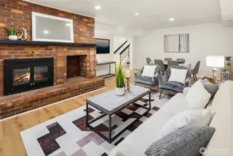 The lower level offers a generous living space with wood-burning fireplace, 3 bedrooms, full hall bath and utility room