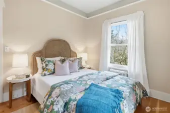 The main floor bedroom looks out to the garden area. The closet has access to the attic with expansion potential.