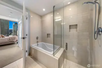 Beautiful tile surrounds the deep soaking tub and separate shower in this ensuite bath.
