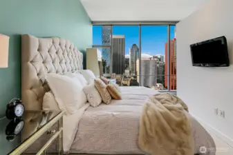Dreamy bedroom with the city lights to entertain day and night.