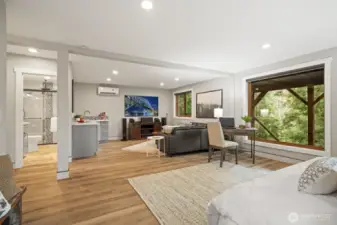 Large windows brighten the lower living area while showcasing peaceful river views.