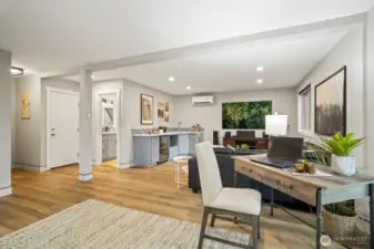 Spacious lower living room with LVP flooring and access to a private 3/4 bathroom.