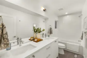 The primary bedroom is an oasis of calm, featuring soft lighting and a spacious, airy layout.