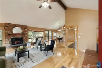 Enter into your inviting great room with vaulted ceilings, wood burning fireplace, tons of natural light and wide plank hickory hardwood floors.