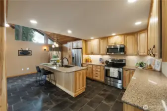 WOW!  So much to admire in this kitchen.  Updated in 2017, custom hickory cabinets feature quartz counters, soft close doors and drawers.  Even the lower cabinets have drawers.  Be sure to check out the custom cabinets next to the range.  With its expansive counters and abundant storage, this is a joy!