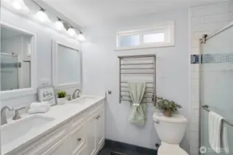 Totally updated!  Double sinks, quartz counters, soft close cabinetry.  New fixtures.  And yes!  A heated towel rack AND heated floors.  Feeling pampered yet?!?!