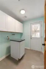 No need to go downstairs for every day living.  This is your laundry room with cabinets and immediate access outside so can also serve your mudroom.