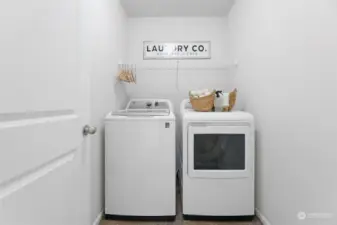 Laundry room has ample space to add additional storage options