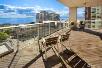 Community room with attached outdoor patio offering stunning views of Elliott Bay and the Olympic Mountains.