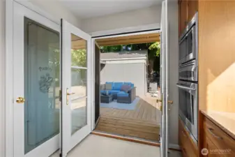 French doors opening to a new deck create such a seamless indoor-outdoor flow—perfect for gatherings and entertaining guests.