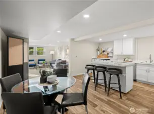 The lower-level kitchen with eating area and floating island features heated tile floors and stainless steel appliances.