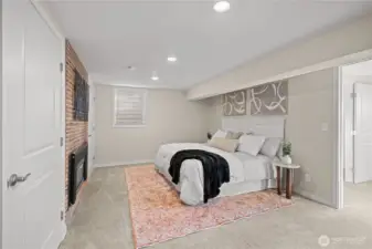 Primary bedroom with ensuite bath, dual closets and gas fireplace.
