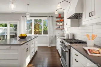 Jenn-Air gas range and custom hood will delight the home chef.