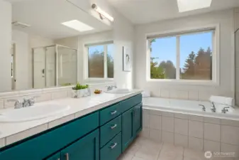 Large en-suite bath with double sink vanity, jetted tub, and additional shower.