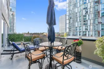 Spacious penthouse terrace offering city skyline views.