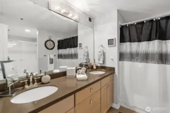 Spa-inspired bath with soaking tub, glass shower, and dual vanity.