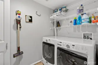 Separate laundry room with full-size appliances and storage