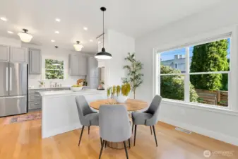 The owners had a rectangular table here that abutted the kitchen peninsula. You can fit a large table in this space!