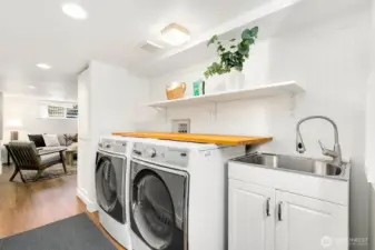 As you go down the basement stairs, you land at the laundry room. Great use of space and still has storage!