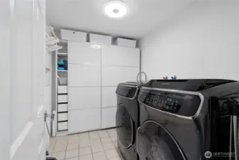This utility room features a high end Samsung washer and dryer, plus space for storing all of your supplies