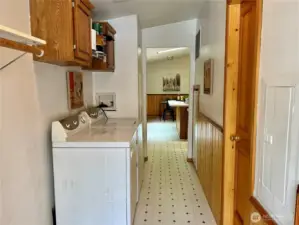 View from laundry room looking towards kitchen. Door to the right offers access to bathroom.