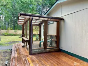 Another view of covered entrance into back of home.  Shelves off a great spot for plants.