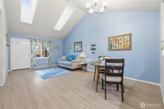 Main living room and dining area. Vinyl plank flooring.