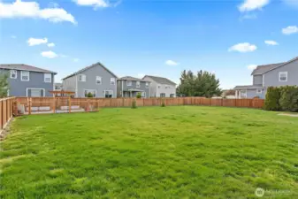 Expansive open flat yard space, freshly landscaped.