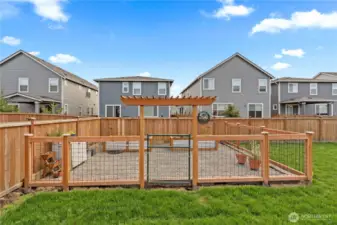 Fenced in garden area with raised beds.