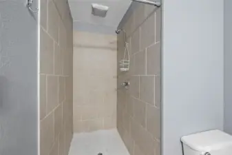Fully tiled large walk-in shower.