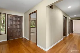 The bright foyer leading to the office/bonus room and the hallway to bedrooms.