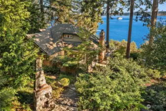 The home is nestled amongst tall trees with gorgeous southern views of Puget Sound, Mt. Rainier and Tacoma.