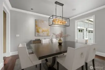 The formal dining room with fresh paint and a new chandelier exudes timeless elegance, perfect for hosting memorable dinners and special occasions. Framed by graceful architectural details and enhanced by rich finishes, space offers an inviting ambiance for gatherings both intimate and grand. Ample natural light, complemented by a statement chandelier, adds warmth and sophistication, making every meal feel like a celebration.
