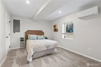 B/Lower Floor: Primary Suite w/Mini-Split for Heat and AC. Walk-In Closet and Electrical Panel for the 2-Bdrm unit.