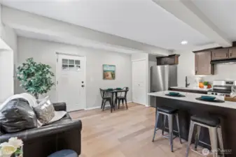 C/Lower Floor: Great Room: Living, Dining, Kitchen w/Laminate Floors, Recessed Lighting and Laundry Closet.