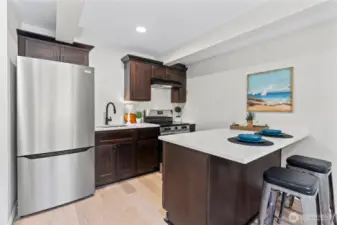 C/Lower Floor: This is the 3rd Kitchen in this unique home! Kitchen w/Fridge and Range. Island easily fits 2 barstools.