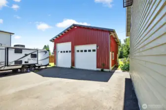 Blacktop entry into shop area and RV area. Lots of parking space.