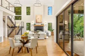 Triple height ceilings with matching hoop chandeliers. Generously proportioned windows all around capture abundant natural light
