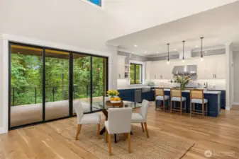 Open informal eating area with huge sliders leading to covered entertaining area.