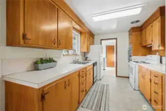 Step in to this "vintage" well-cared for kitchen. Tons of counter space and a window over the sink to look out to the backyard.