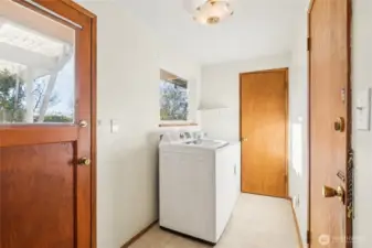 Just past the kitchen is the laundry room, plus at the end is a roomy storage closet. Door to the left takes you to the backyard. Door to the right to the garage.