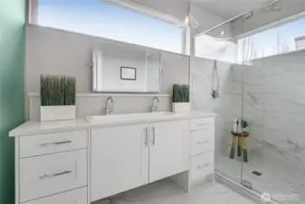 Elegant primary bath with glass-enclosed shower.