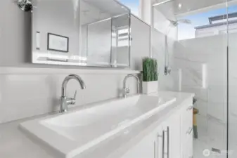Refined primary bathroom with shared sink design and modern fixtures.