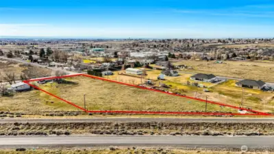 RR tracks border this side of the property. Maple Drive is at the front. The house right next door is occupied and not part of the vacant land listing.