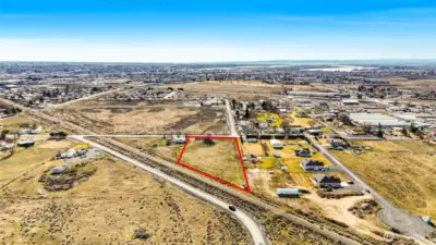 Another view of the property, level, ready for you to get your permits and build on it since it has electricity and septic.  Needs a well but has a possibility of a shared well with home right next door. The house right next door is occupied and not part of the vacant land listing. (Please don't knock on the door of the tenant's home next door.)