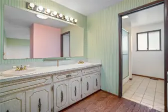 The primary bathroom has a long vanity and double sinks as well as a walk-in shower.