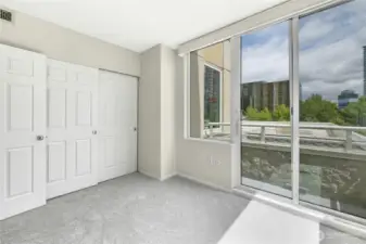 Closet space and balcony view in second bedroom.