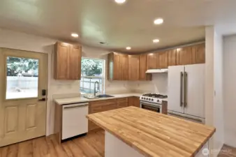 Brand new kitchen with solid wood cabinets, upscale appliances, 5 burner gas range