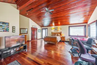 Spacious and versatile! This primary retreat boasts vaulted ceilings, a large walk-in closet, a luxurious jetted tub, plus dedicated office and exercise areas—all designed for comfort and convenience in one stunning space.